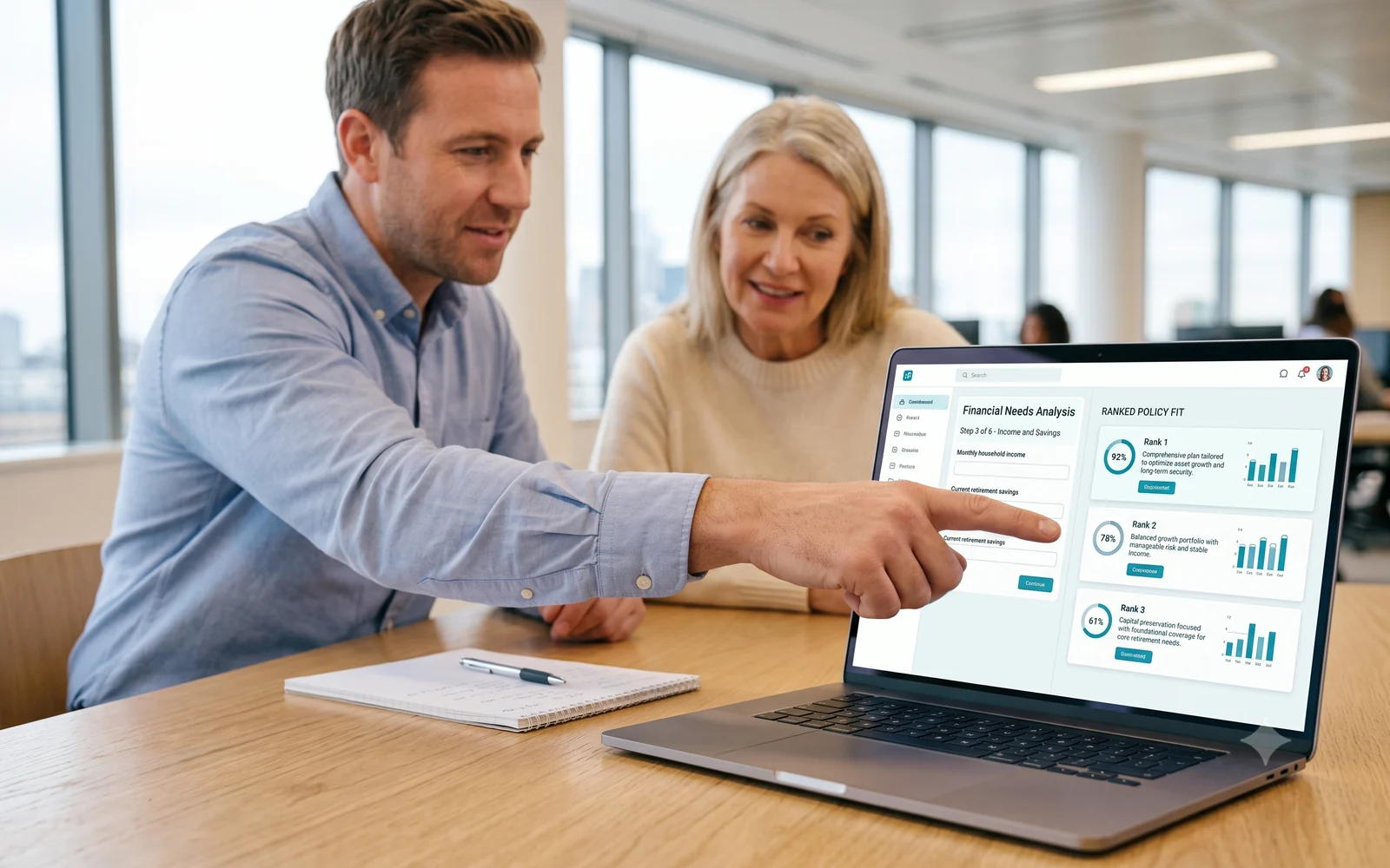 An advisor sitting beside a client, pointing at the ranked policy fit on his laptop during a live financial needs analysis